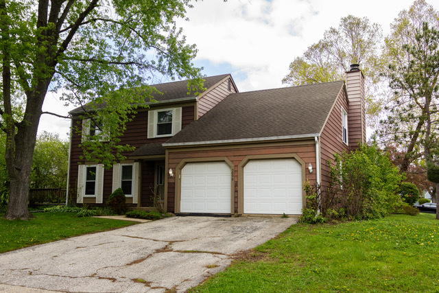 5090 Prairie Oak Road Gurnee, IL 60031 - Photo 3 of 30 a front view of a house with a yard and garage