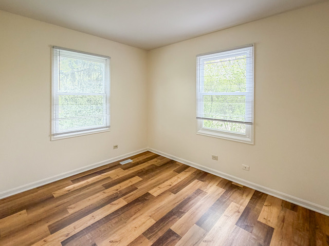 5090 Prairie Oak Road Gurnee, IL 60031 - Photo 8 of 30 a view of a room with wooden floor and a window