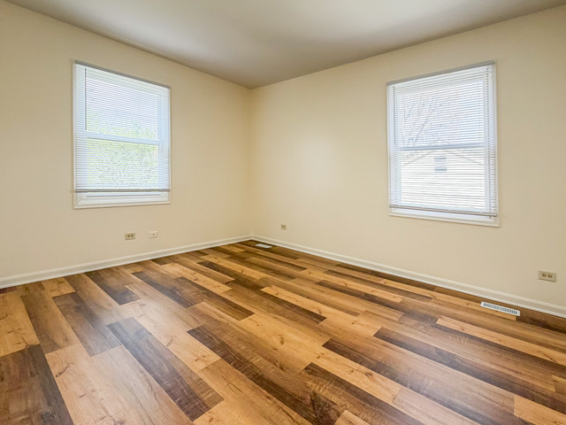 5090 Prairie Oak Road Gurnee, IL 60031 - Photo 10 of 30 a view of a room with wooden floor and a window