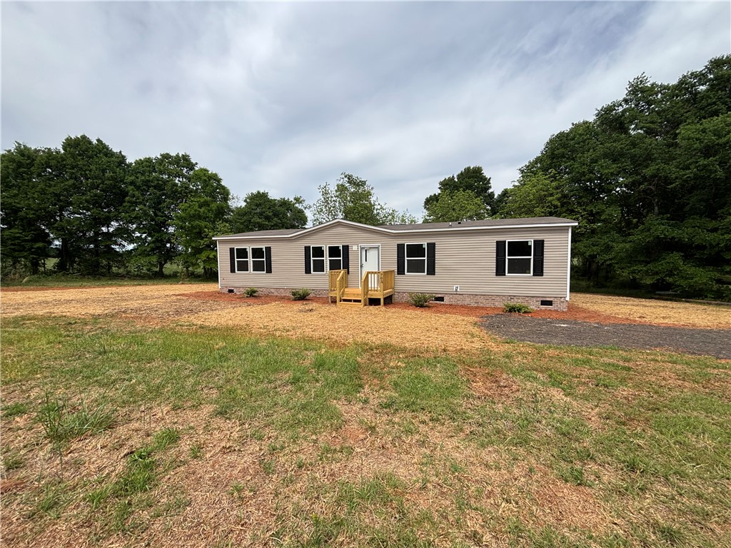 703 Double Springs Road Townville, SC 29689 - Photo 1 of 22 This charming residence offers comfortable living in a serene, natural setting.
