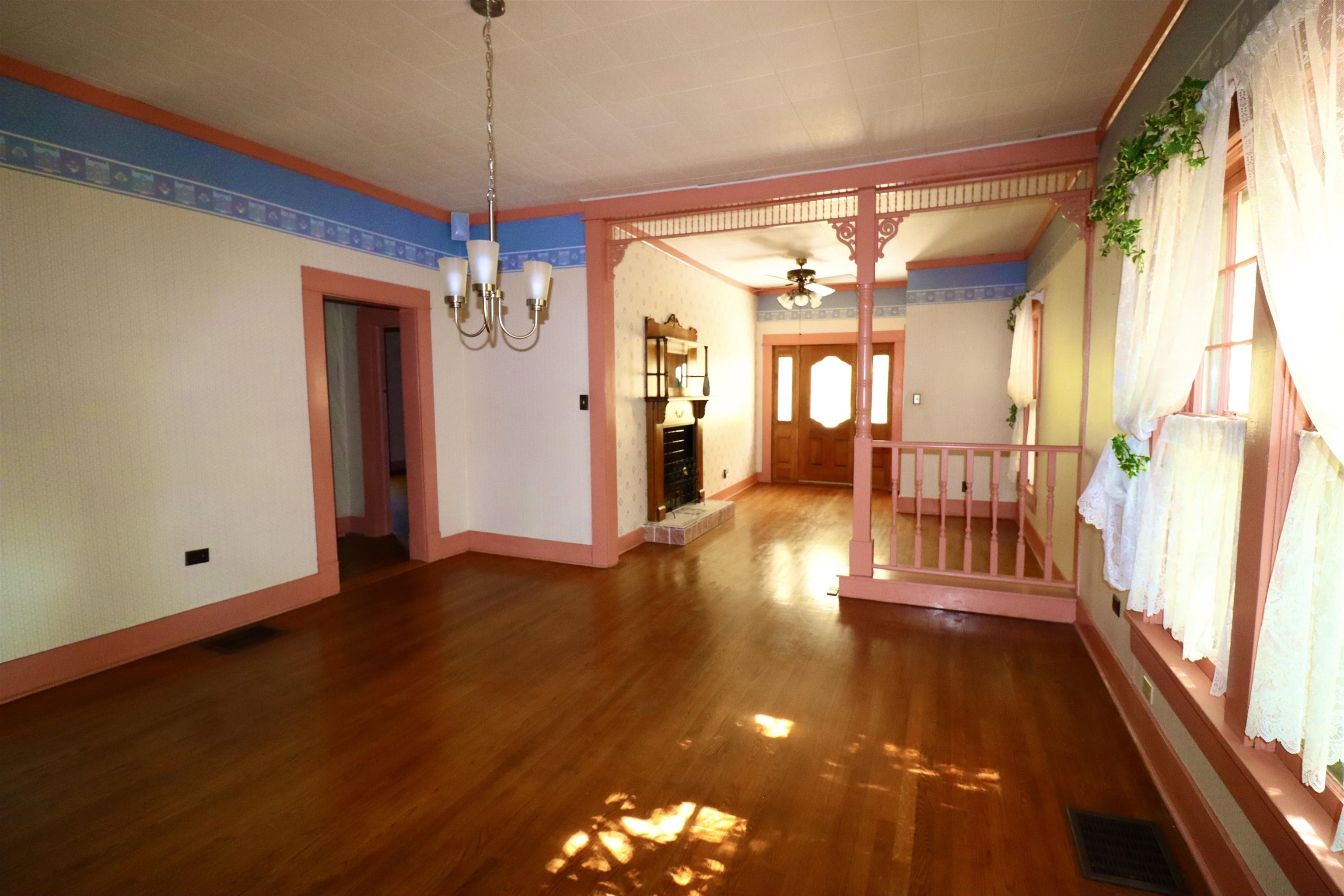 317 Purdy Road Selmer, TN 38375 - Photo 15 of 38 Unfurnished dining area with dark hardwood / wood-style floors and ceiling fan with notable chandelier