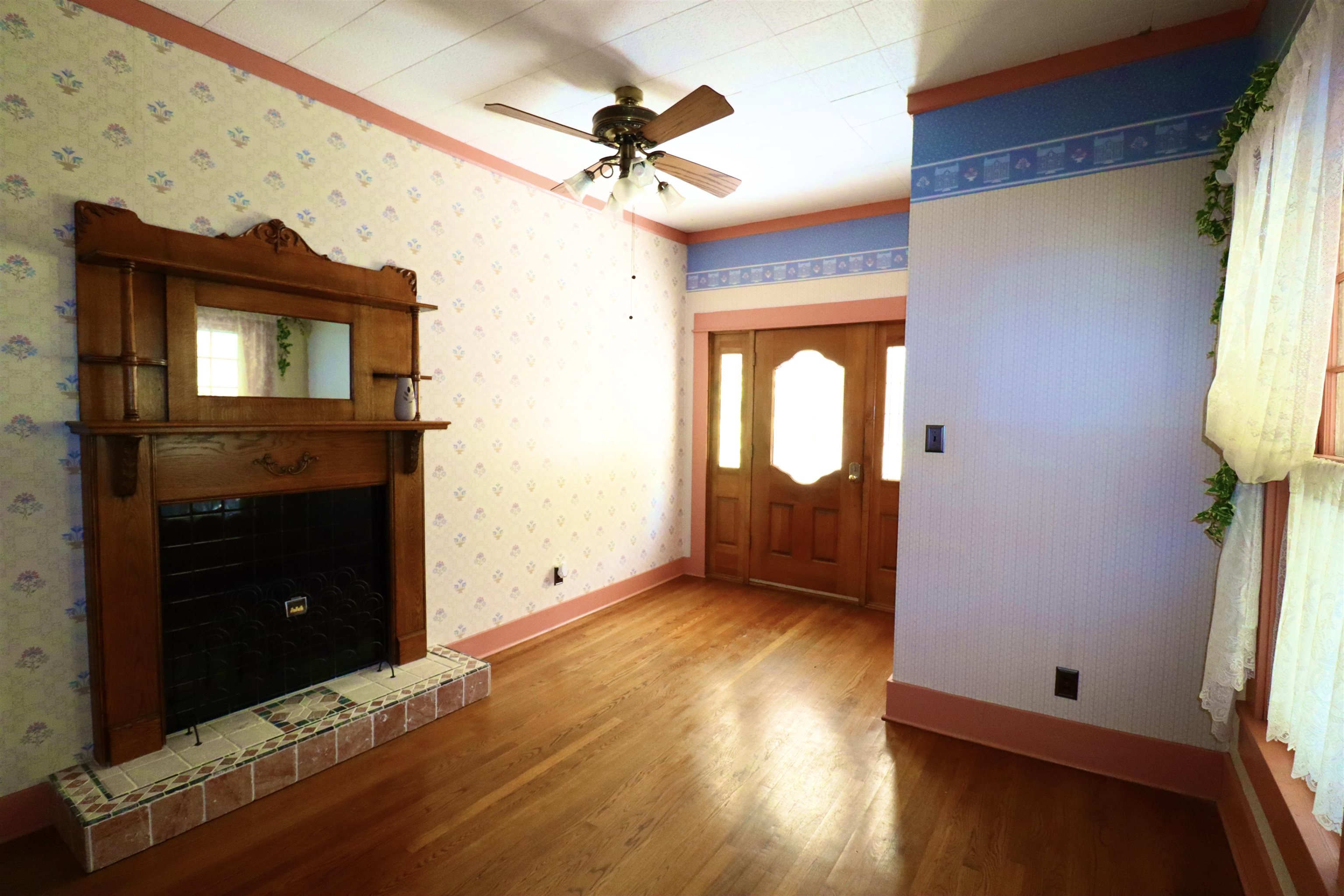 317 Purdy Road Selmer, TN 38375 - Photo 16 of 38 Foyer featuring hardwood / wood-style floors, ceiling fan, and a tiled fireplace