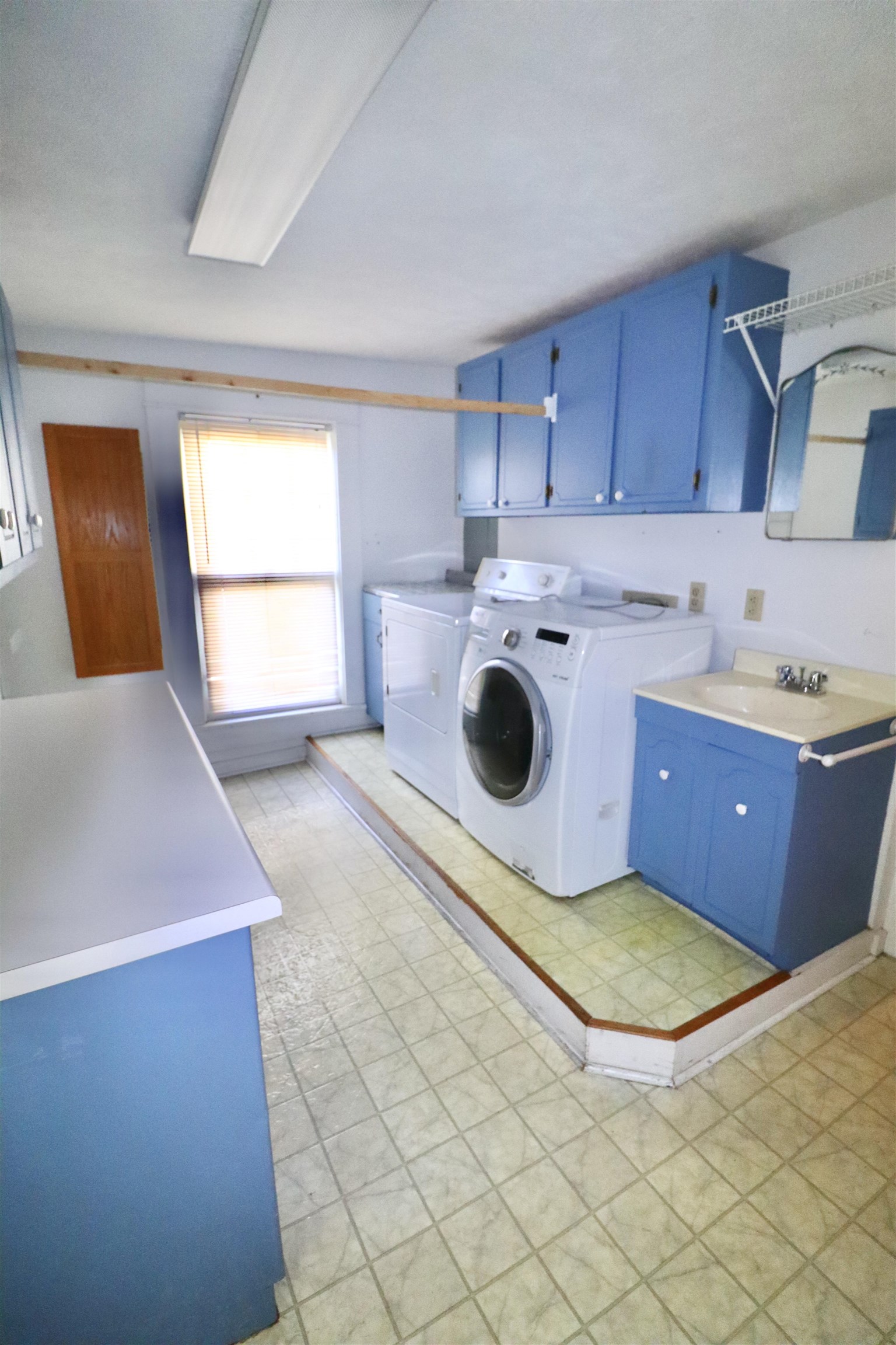 317 Purdy Road Selmer, TN 38375 - Photo 21 of 38 Laundry room with washer and dryer, cabinets, sink, and light tile patterned floors