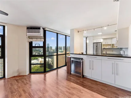 a large kitchen with stainless steel appliances granite countertop a stove and a refrigerator