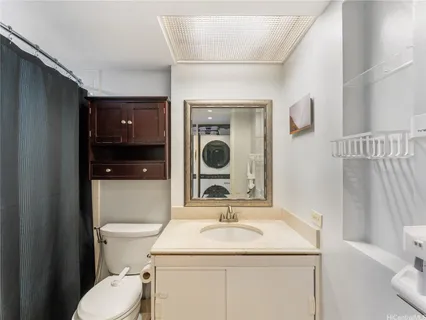 a bathroom with a sink toilet and mirror