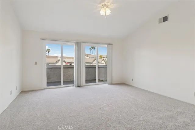 a spacious bedroom with a bed and a chandelier