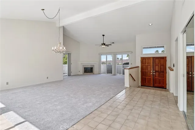 a large white room with windows and chandelier