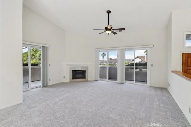 a kitchen with stainless steel appliances granite countertop a refrigerator a sink a stove a dining table and chairs