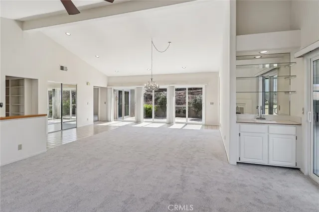 a kitchen with stainless steel appliances granite countertop a sink refrigerator and cabinets