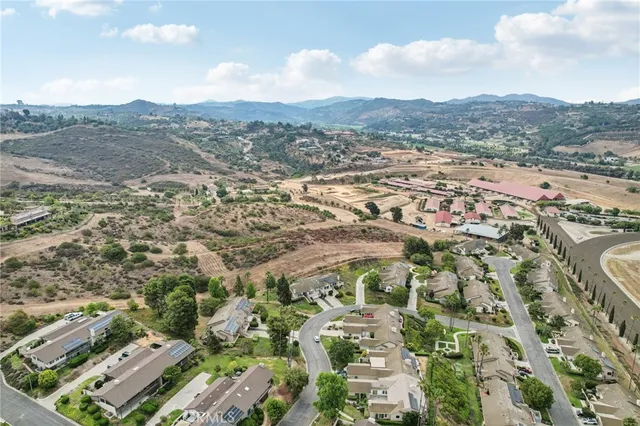 an aerial view of a house with a yard and lake view