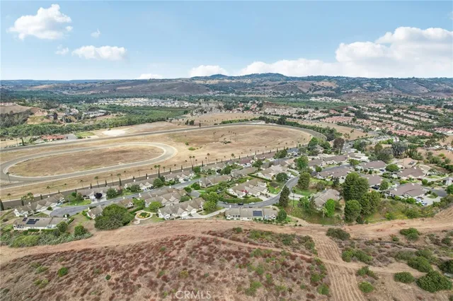 an aerial view of residential houses with outdoor space and river