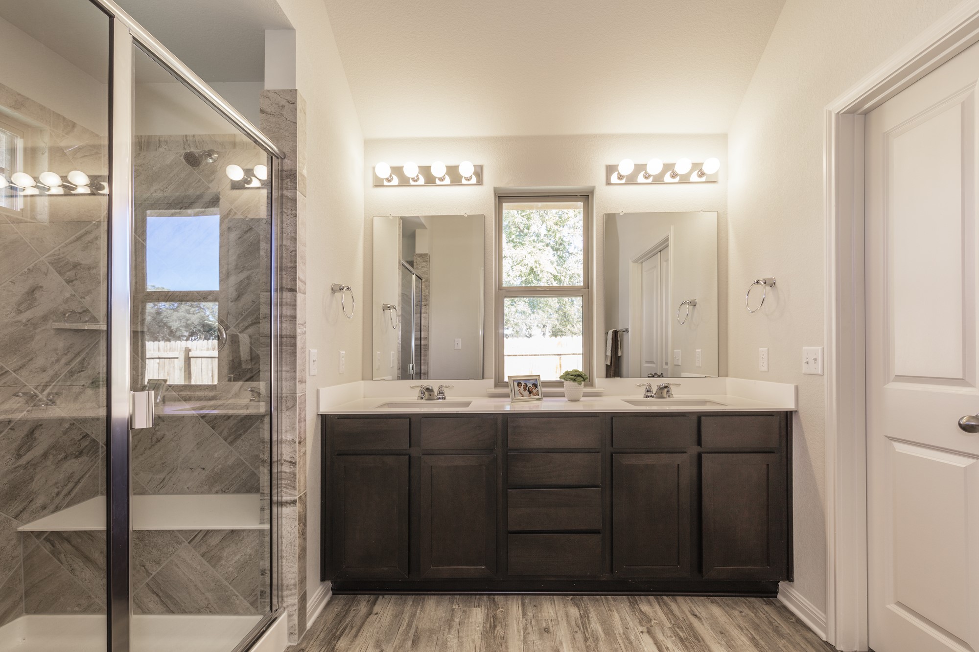 2725 Hopi Path Leander, TX 78641 - Photo 29 of 30 A well-appointed primary bathroom featuring a spacious dual vanity and a walk-in shower with tiled walls.