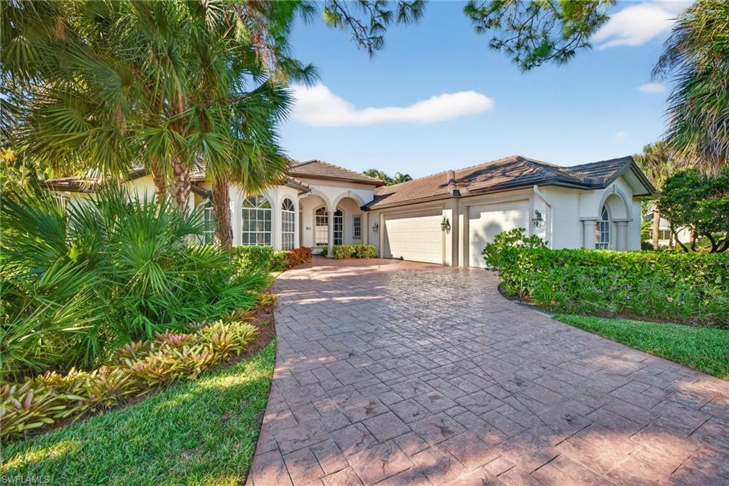 2229 Goshawk Court Naples, FL 34105 - Photo 1 of 27 a view of a white house with a small yard and a large tree