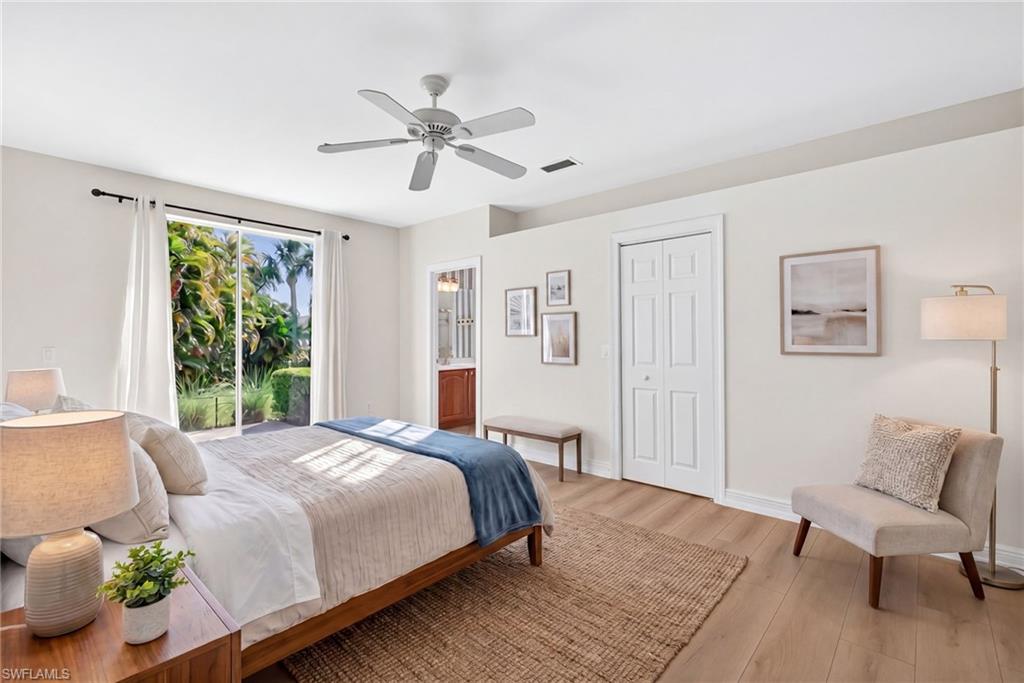 2229 Goshawk Court Naples, FL 34105 - Photo 12 of 27 a bedroom with a bed and wooden floor