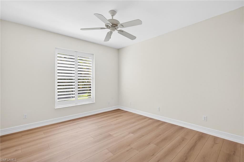 2229 Goshawk Court Naples, FL 34105 - Photo 14 of 27 wooden floor in an empty room with a window