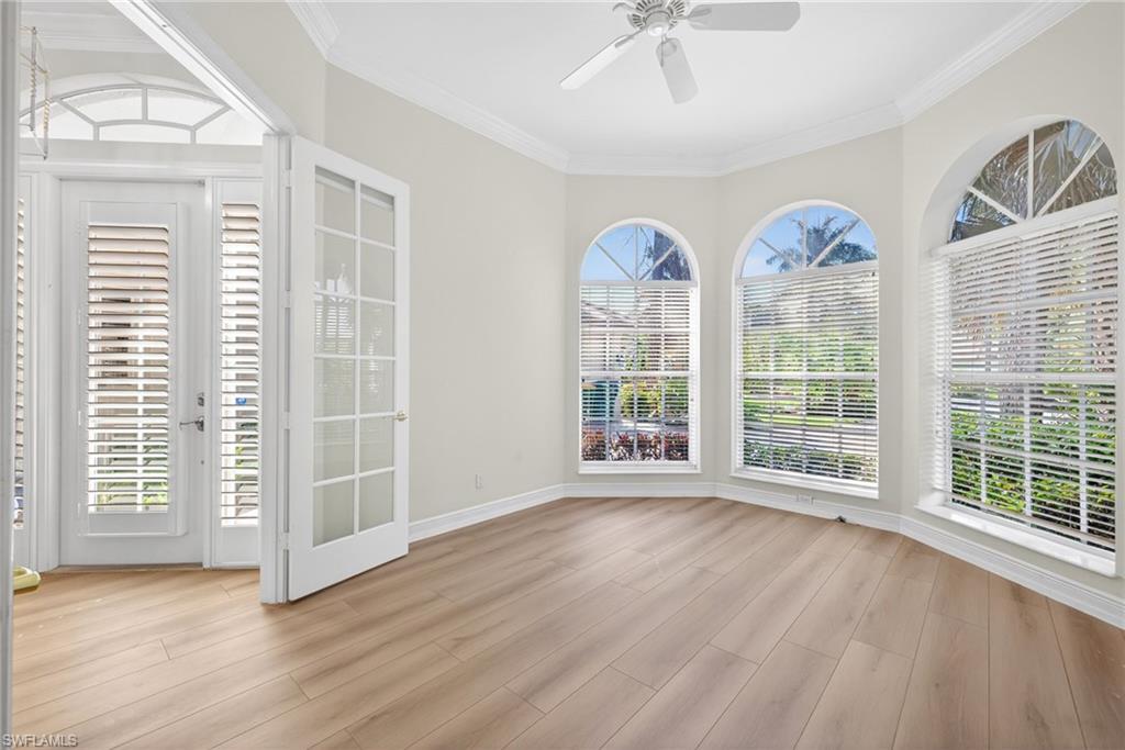 2229 Goshawk Court Naples, FL 34105 - Photo 16 of 27 a view of an empty room with wooden floor and a window