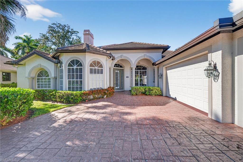 2229 Goshawk Court Naples, FL 34105 - Photo 23 of 27 a front view of a house with garden