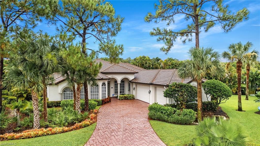 2229 Goshawk Court Naples, FL 34105 - Photo 24 of 27 a front view of a house with a yard