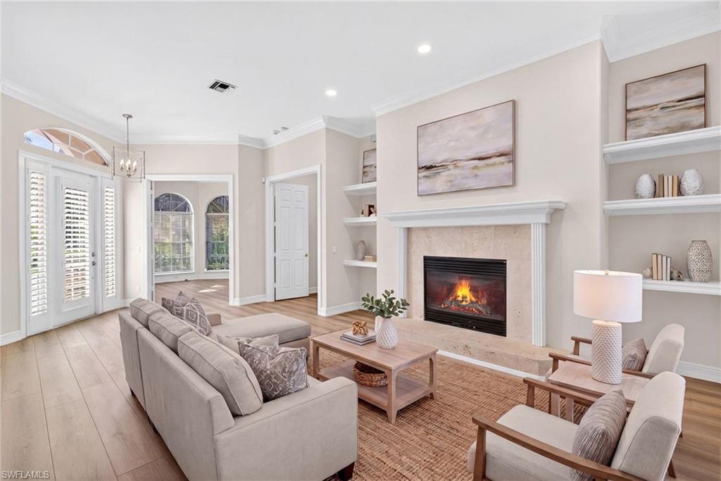 2229 Goshawk Court Naples, FL 34105 - Photo 3 of 27 a living room with furniture and a fireplace