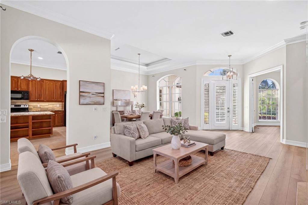 2229 Goshawk Court Naples, FL 34105 - Photo 4 of 27 a living room with furniture fireplace and a large window