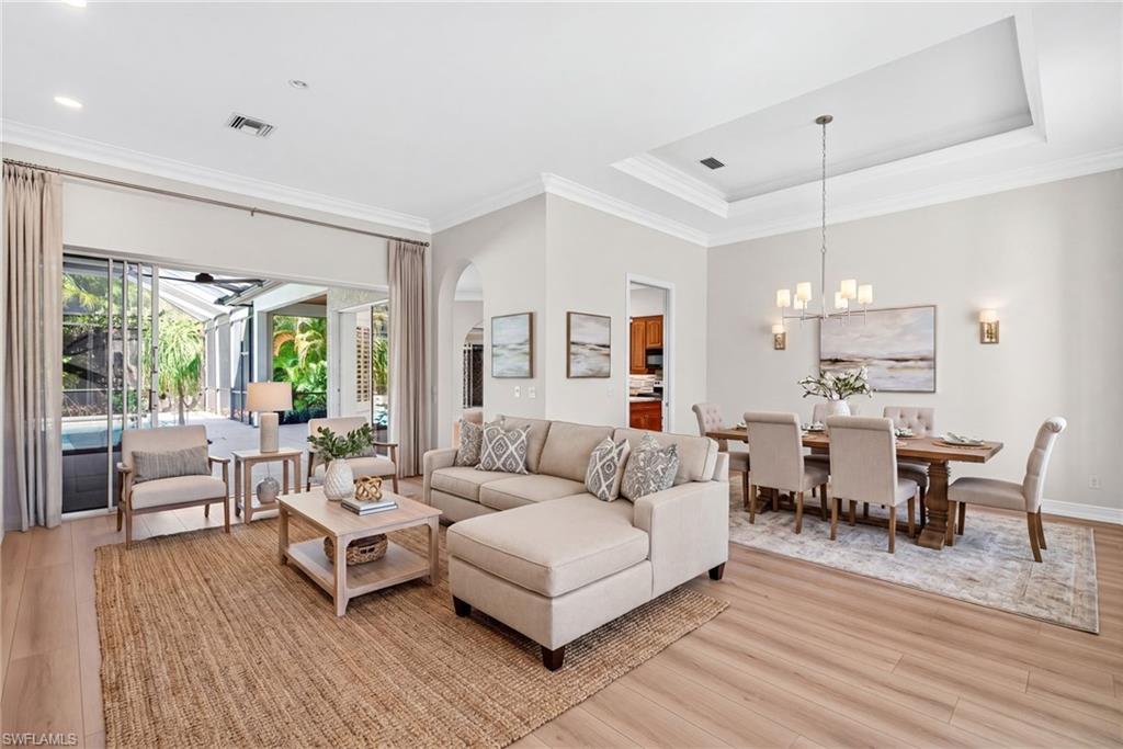 2229 Goshawk Court Naples, FL 34105 - Photo 5 of 27 a living room with furniture and a wooden floor