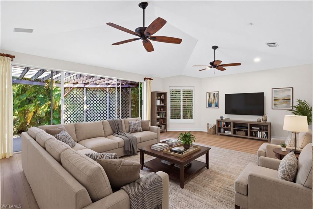 2229 Goshawk Court Naples, FL 34105 - Photo 8 of 27 a living room with furniture and a flat screen tv