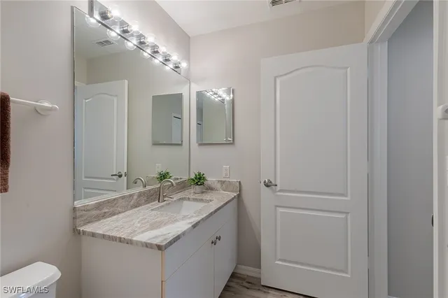 a white toilet sitting next to a bathroom sink
