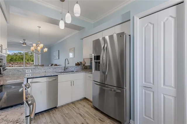 a living room with furniture a flat screen tv and a large window