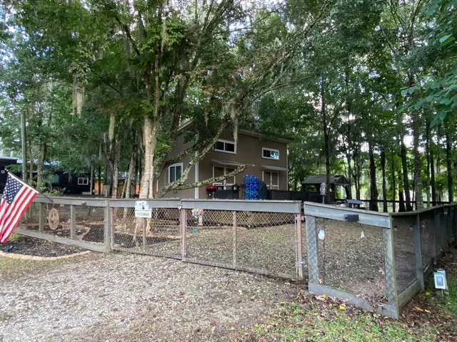 a view of a house with backyard and sitting area