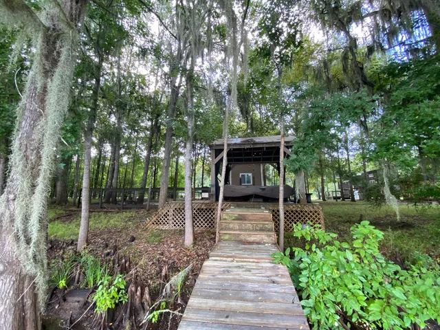 a view of balcony with wooden floor and fence