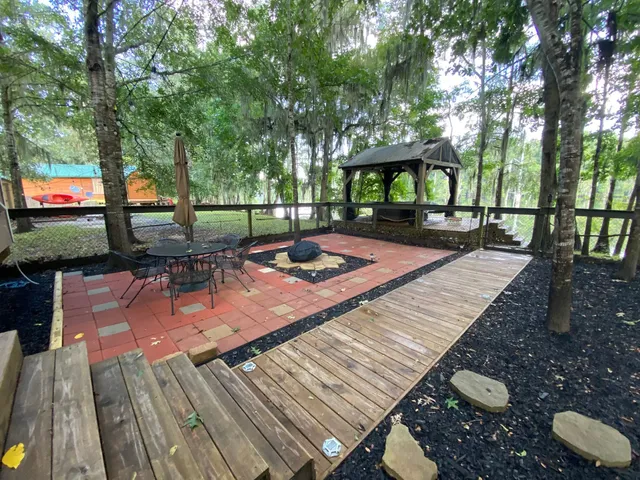 a view of a backyard with sitting area