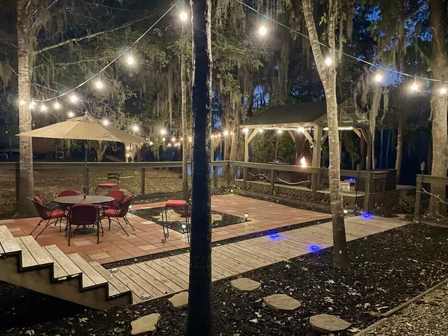 a view of a patio with table and chairs and potted plants