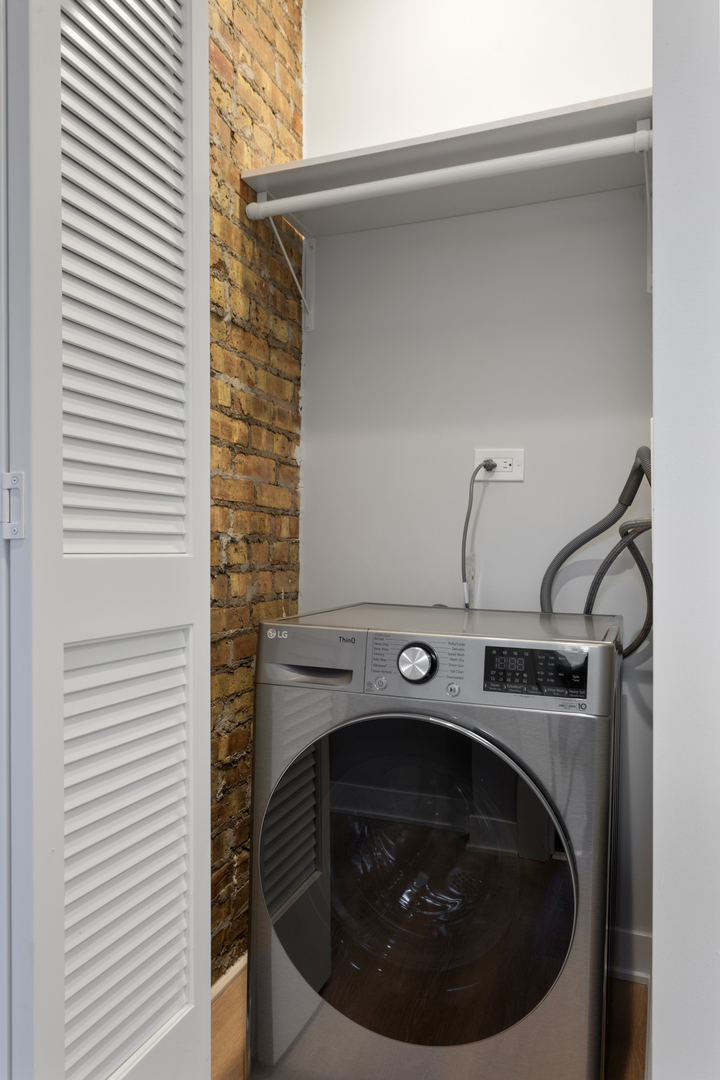 7383 North Damen Avenue, Unit 2W Chicago, IL 60645 - Photo 11 of 13 a utility room with washing machine