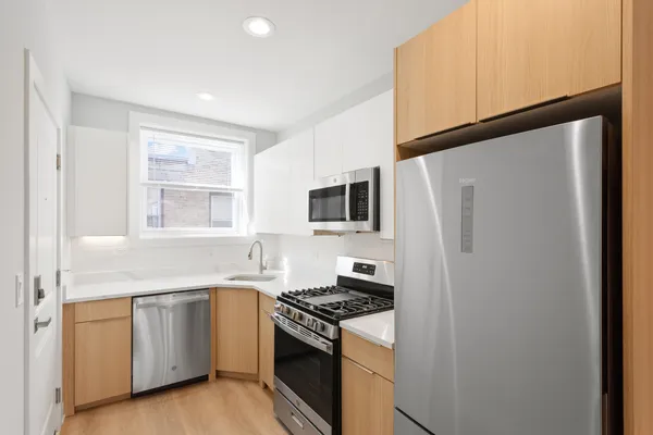 a kitchen with white cabinets and white appliances