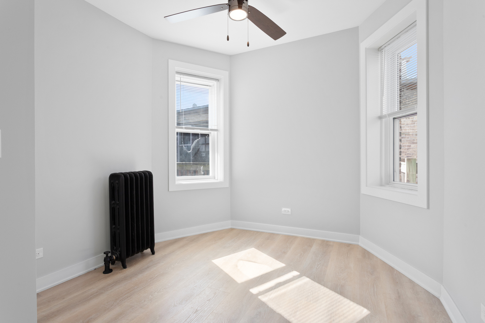7383 North Damen Avenue, Unit 2W Chicago, IL 60645 - Photo 10 of 13 an empty room with windows and closet