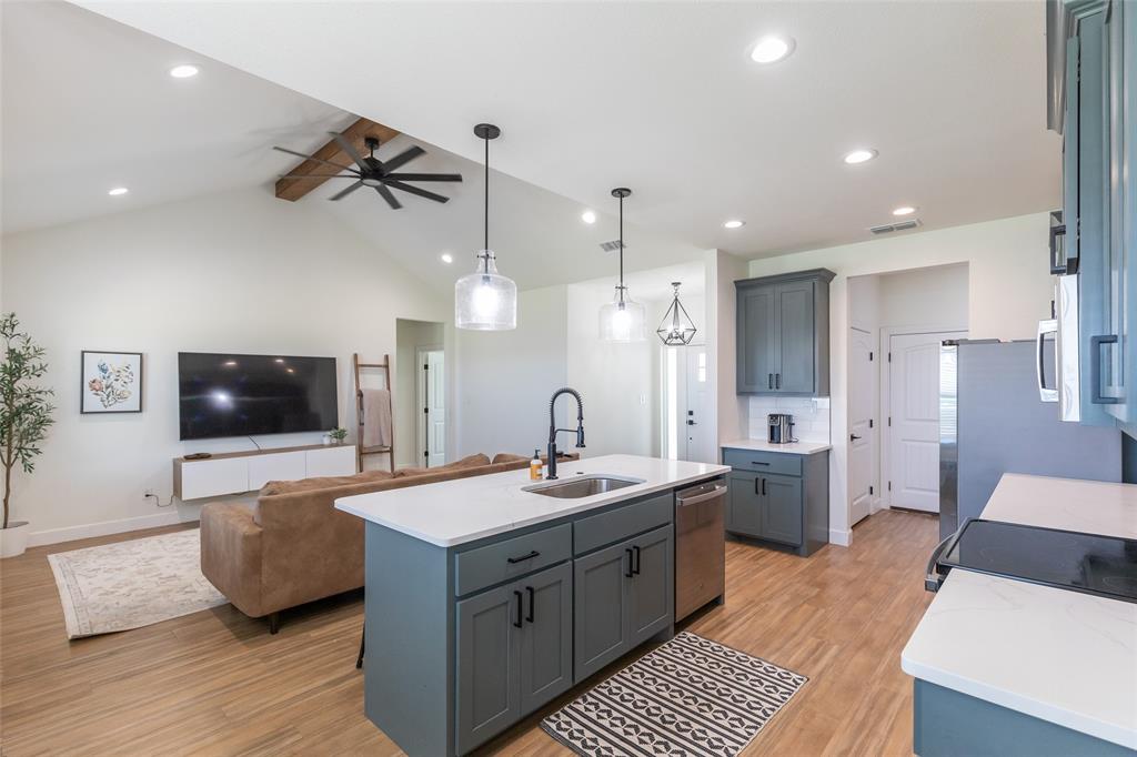 118 Corbyn Circle Tuscola, TX 79562 - Photo 11 of 36 a large kitchen with stainless steel appliances a large counter top a sink dishwasher a refrigerator and a flat screen tv