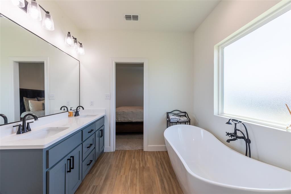 118 Corbyn Circle Tuscola, TX 79562 - Photo 19 of 36 a bathroom with a tub sink and mirror
