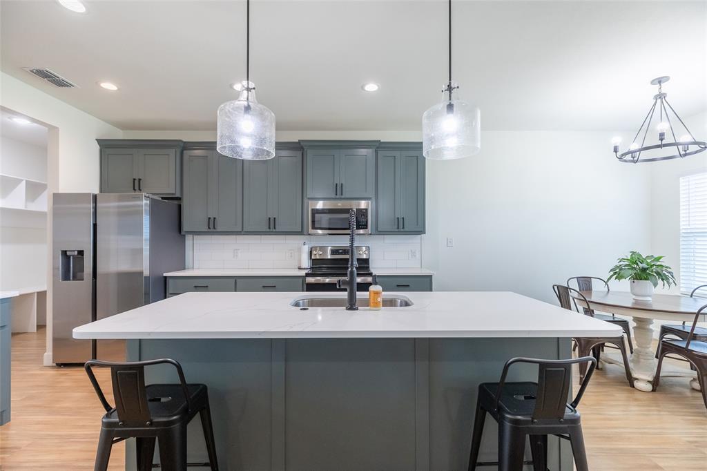 118 Corbyn Circle Tuscola, TX 79562 - Photo 6 of 36 a kitchen with a dining table chairs sink and stove