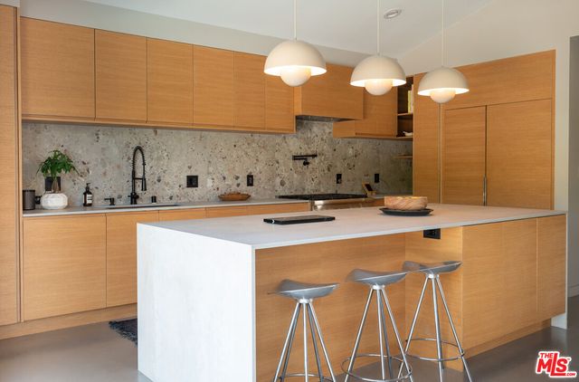 a dining room with furniture and a floor to ceiling window
