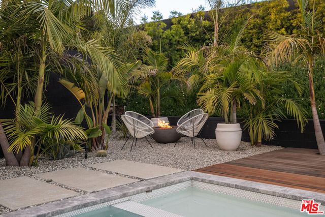 a view of an outdoor dining space with a table and chairs