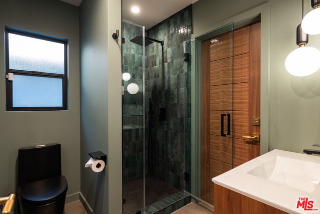 a kitchen with a sink and chandelier