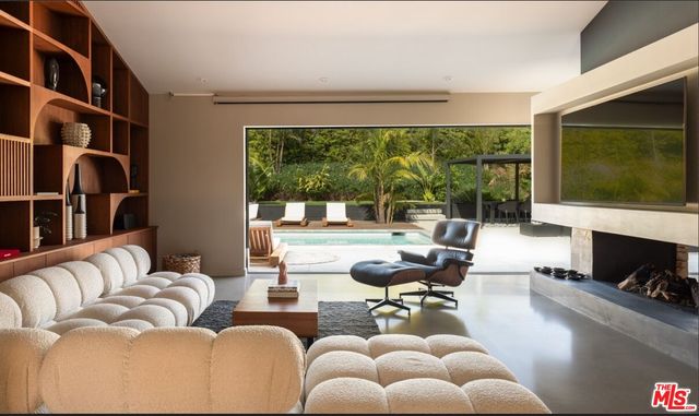 a view of a livingroom with workspace and a window