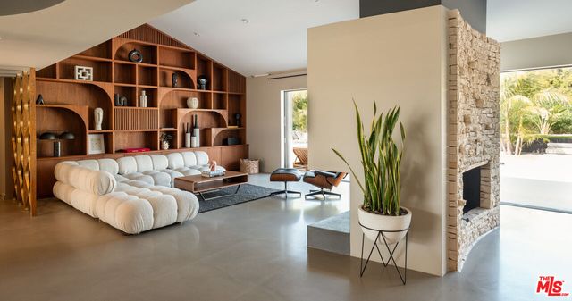 a view of a livingroom with furniture and a flat screen tv