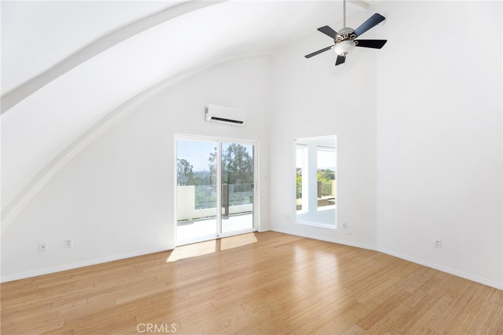 22870 Trigger Street Chatsworth, CA 91311 - Photo 33 of 64 an empty room with wooden floor and windows