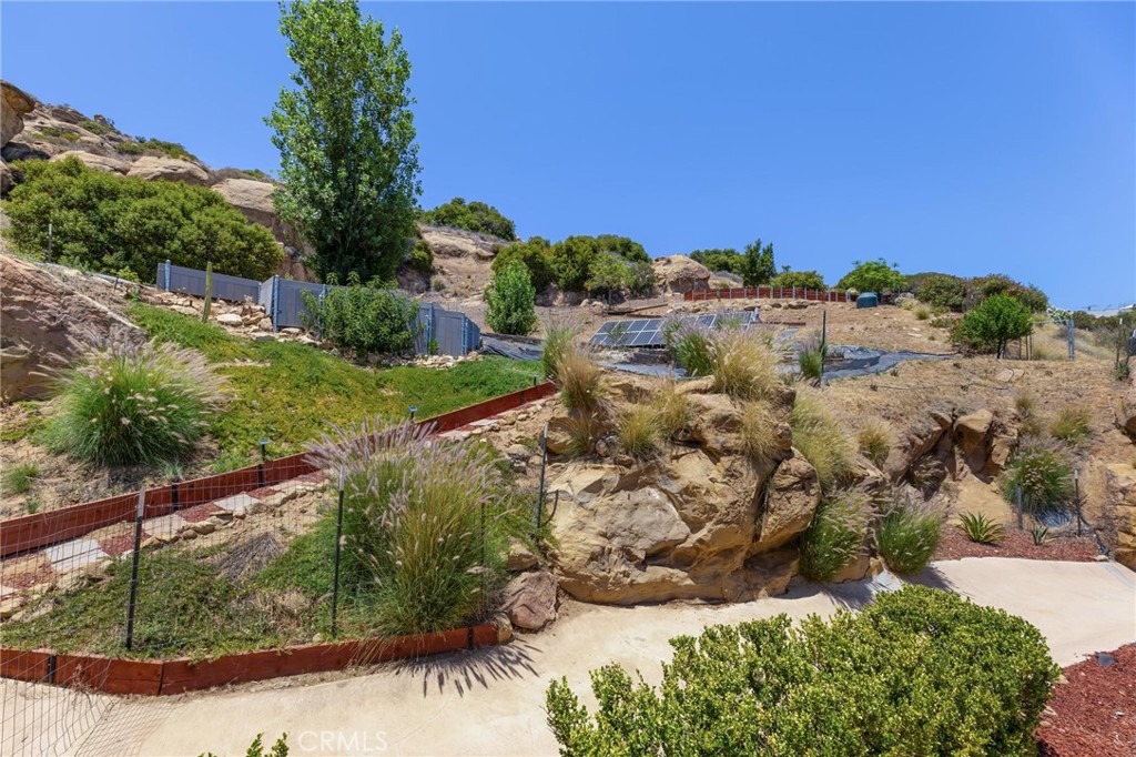 22870 Trigger Street Chatsworth, CA 91311 - Photo 44 of 64 a view of a garden with a building in the background
