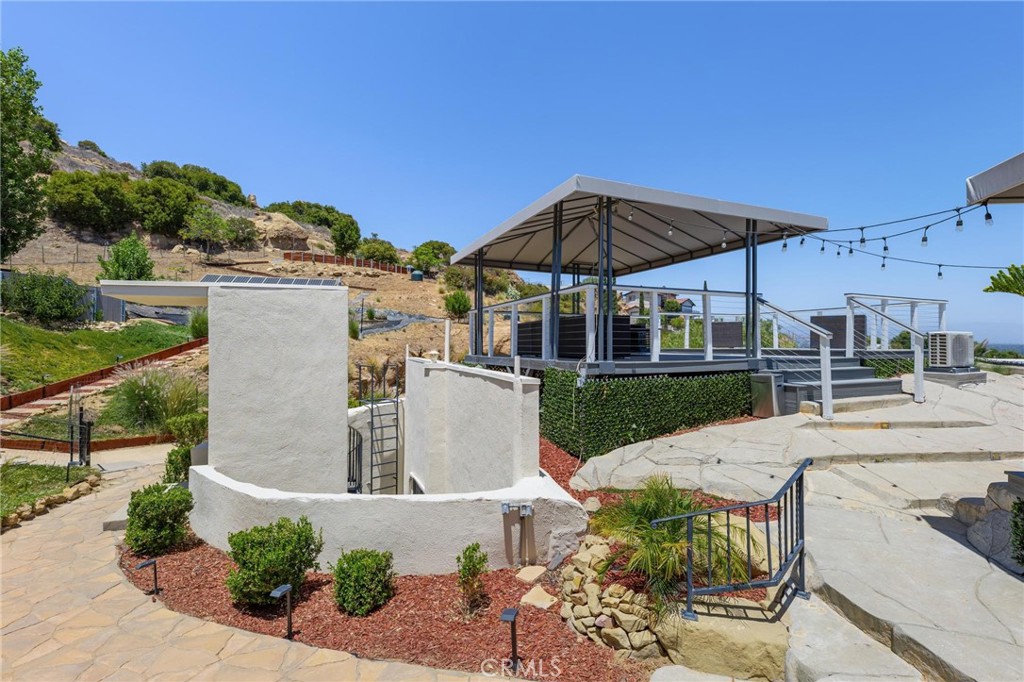 22870 Trigger Street Chatsworth, CA 91311 - Photo 50 of 64 a view of a patio with table and chairs under an umbrella