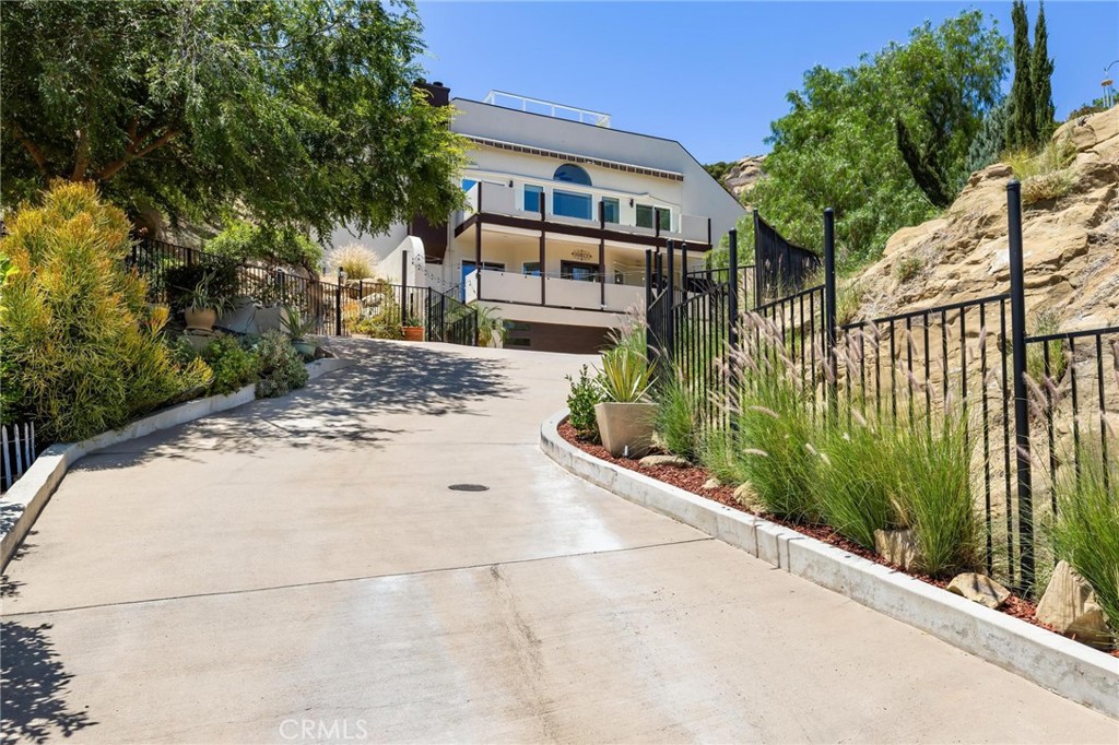 22870 Trigger Street Chatsworth, CA 91311 - Photo 63 of 64 a front view of a house with a yard