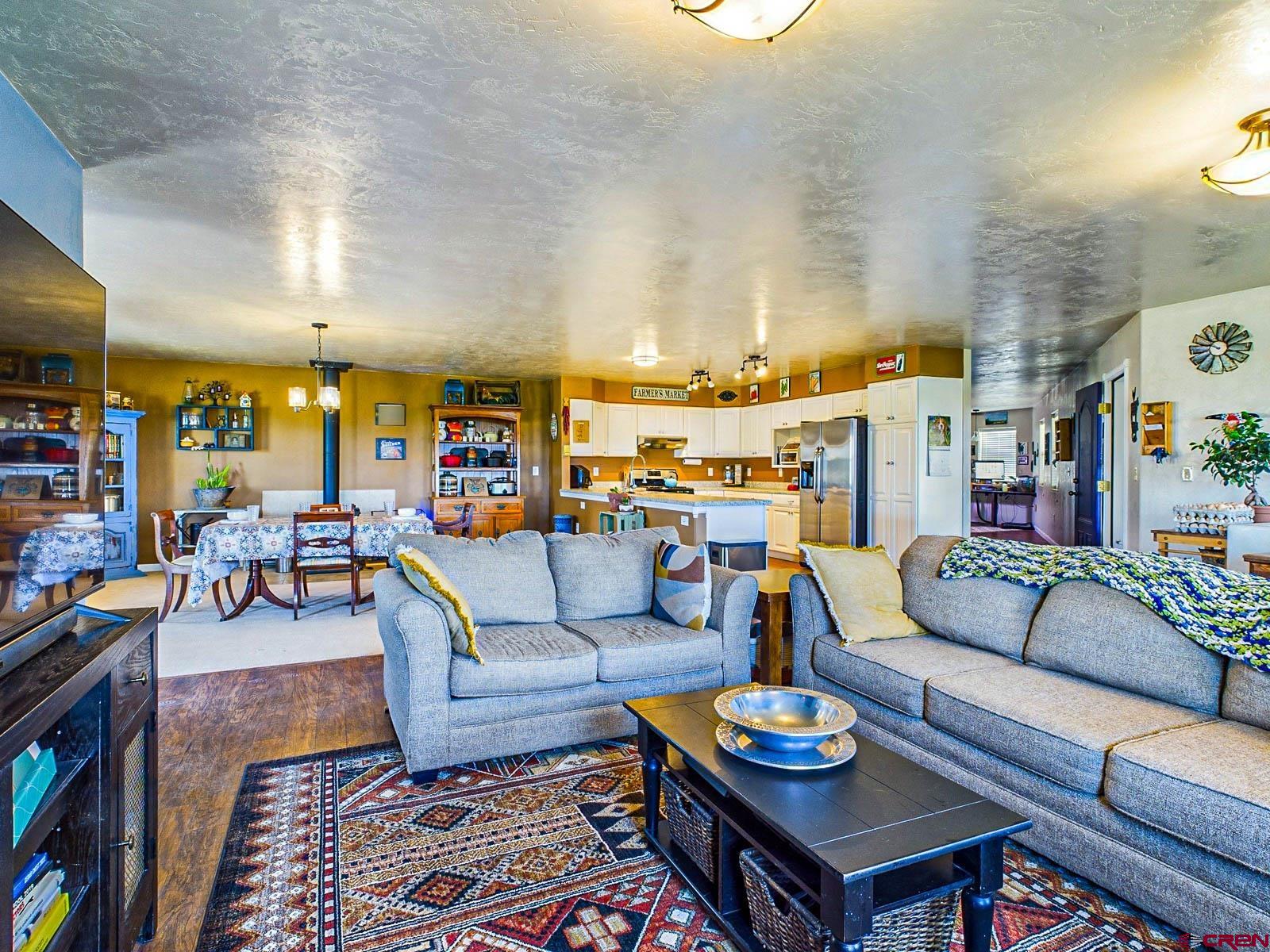 20260 Fawn Circle Eckert, CO 81418 - Photo 14 of 35 a living room with furniture kitchen view and a table