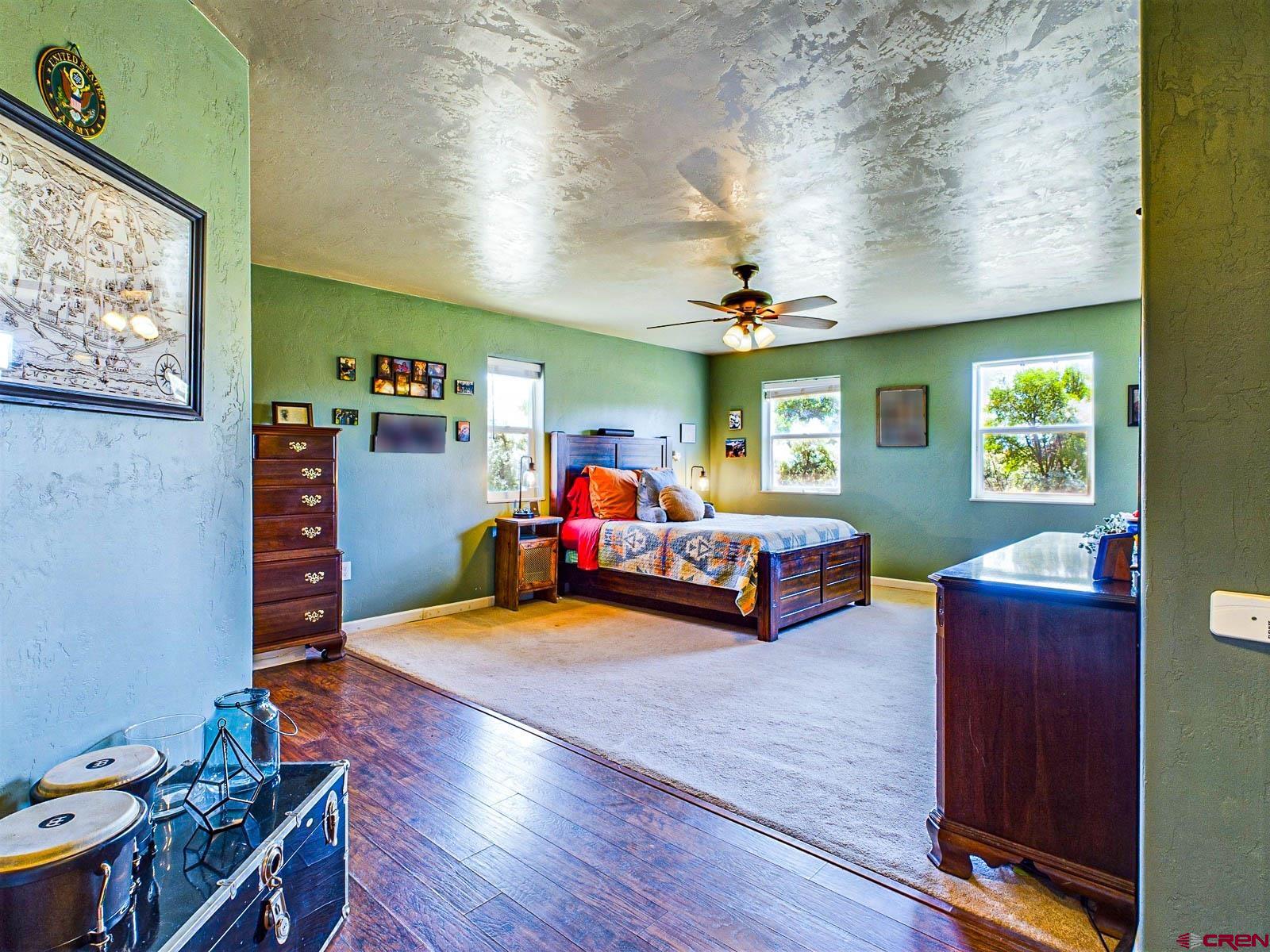 20260 Fawn Circle Eckert, CO 81418 - Photo 17 of 35 a bedroom with furniture and a wooden floor