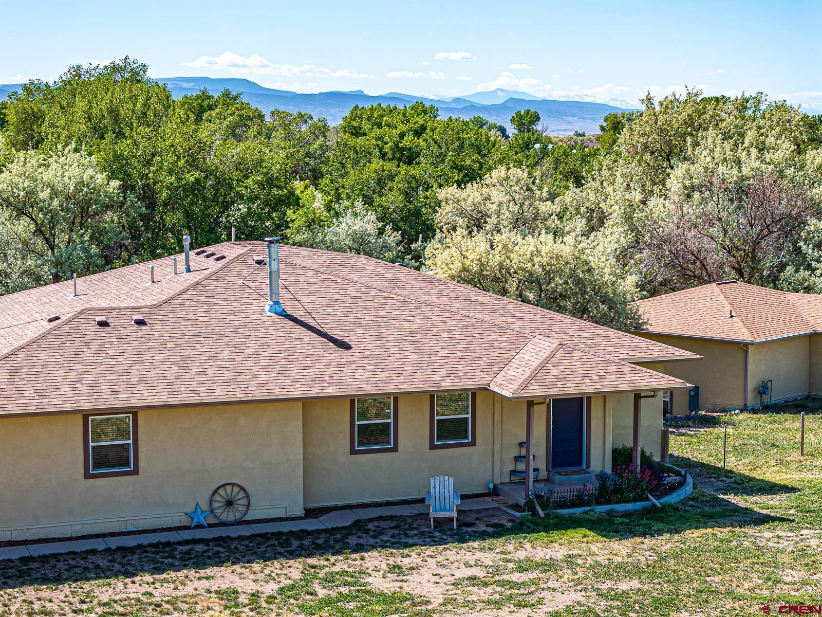 20260 Fawn Circle Eckert, CO 81418 - Photo 2 of 35 a backyard of a house with yard table and chairs